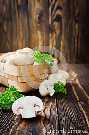 Ð¡hampignons with parsley in a basket Stock Photo