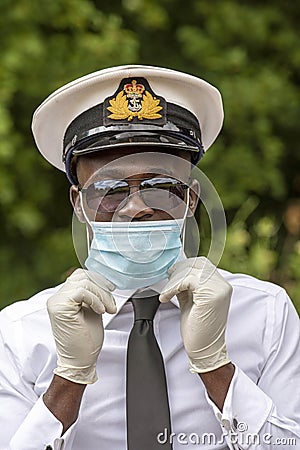 Naval officer wearing mask and gloves during Covid-19 Editorial Stock Photo