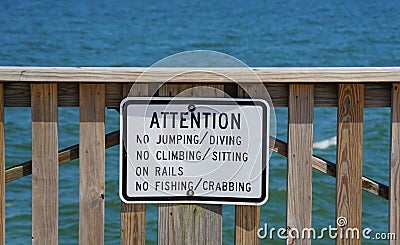 A warning sign on the pier off Buckroe Beach that do not allow jumping, diving, Editorial Stock Photo