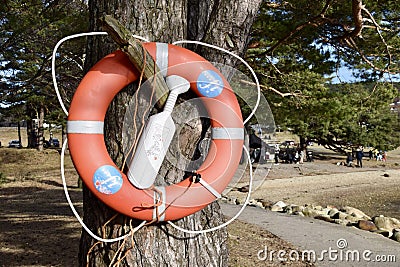Hamresanden, Norway, February 26, 2023. Life Bouy Ring at Hamresanden Beach attached to a tree. Editorial Stock Photo