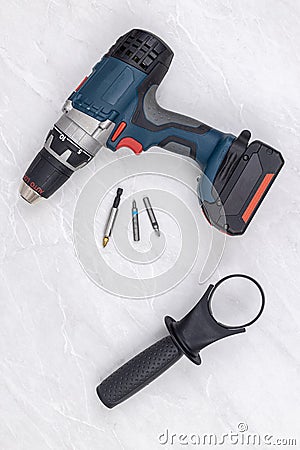 Hand accu battery drill on the white background with hand mount holder Stock Photo