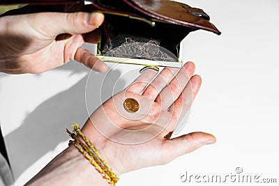 The hand of an adult holds cents Stock Photo