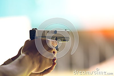 Hand aim pistol in academy shooting range Stock Photo