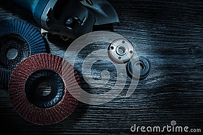 Hand angle grinder radial abrasive discs on vintage wooden board Stock Photo