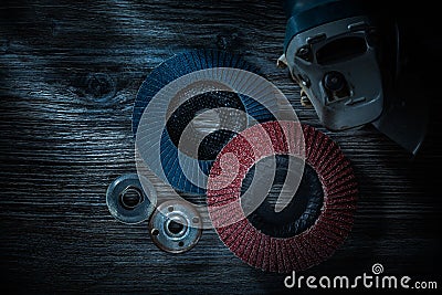 Hand angle grinder rotary polishing disc on vintage wooden board Stock Photo