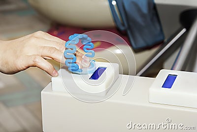 Hand applies the bracelet to the turnstile for passage through the ticket system. Stock Photo