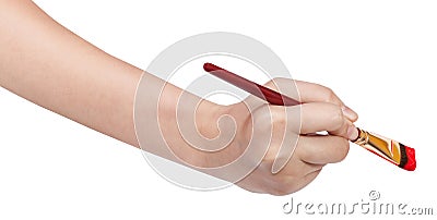 Hand with artistic flat paintbrush paints in red Stock Photo