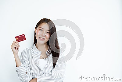 The hand of an Asian woman holding a credit card is used for online shopping and Internet payments Stock Photo