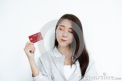The hand of an Asian woman holding a credit card is used for online shopping and Internet payments Stock Photo