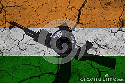 Hand assault rifle on the background of the flag of India and cracks. India Power Concept Stock Photo