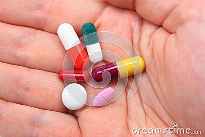 Hand with assorted pills Stock Photo