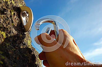 Hand attaching carabiner Stock Photo