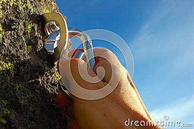 Hand attaching carabiner Stock Photo