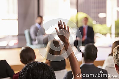 Hand in audience raised for a question at a business seminar Stock Photo