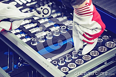 Hand of auto mechanic picking spanner out of tools drawer Stock Photo