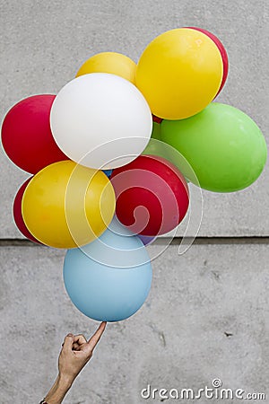 Hand balancing a lot of balloons Stock Photo