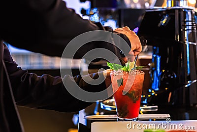 Hand bartender make cocktail. Cocktail have cherry and mint leaves Stock Photo