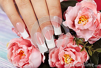 Hand with beautiful long artificial french manicured nails Stock Photo