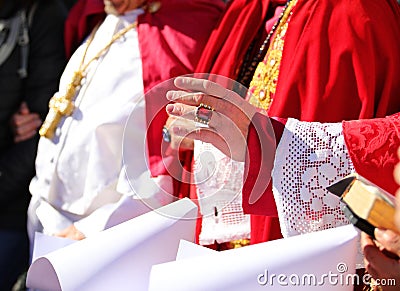 Bishop s hand in clerical attire blessing nuns standing before him Stock Photo