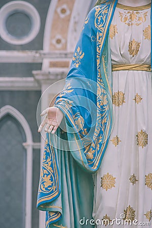 Hand of The Blessed Virgin Mary statue standing in front of The Roman Catholic Diocese that is public place. Stock Photo