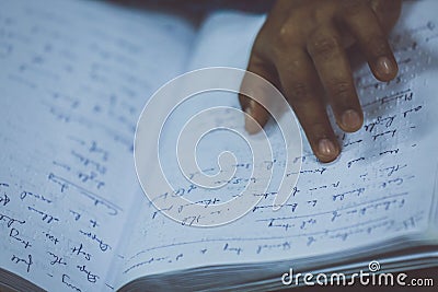 A hand of a blind person reading a braille system book Editorial Stock Photo