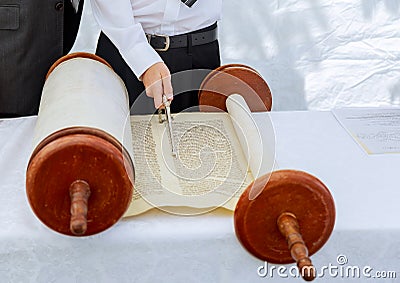 Hand of boy reading the Jewish Torah at Bar Mitzvah Stock Photo