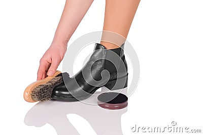 Hand with brush cleaning shoes Stock Photo