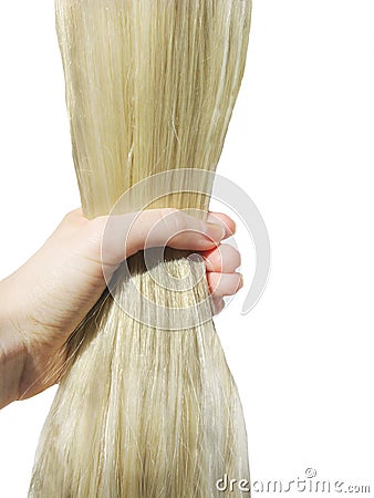 Hand brushing shiny long blond hair Stock Photo