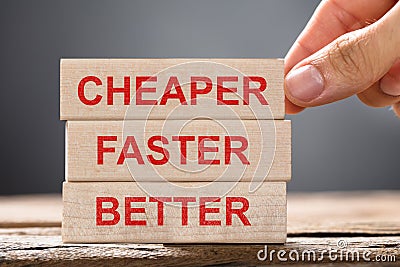 Person Placing Cheaper, Faster And Better Wooden Blocks Stock Photo