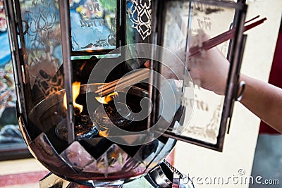 Hand burning incense Stock Photo