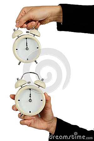 Hand of business hold alarm clock with showing 12 o`clock isolated on white - Time concept Stock Photo