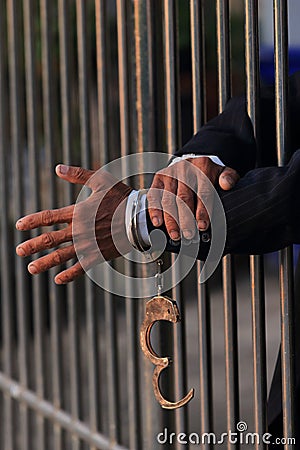 Hand of business man in jail Stock Photo