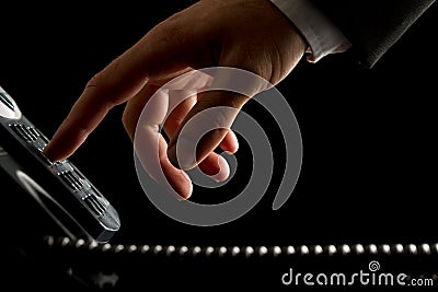 Hand of a businessman dialing or initiating a call Stock Photo
