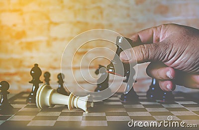 Hand of businessman moving chess figure to win competition play. ,business strategy success concept Stock Photo