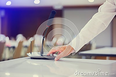 The hand of businessman is pressing to power on wireless Conference microphones in a meeting room Stock Photo