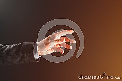 Hand of a businessman reaching for the light of hope Stock Photo