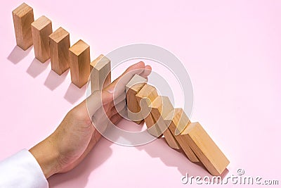 Hand of businessman stop dominoes continuous toppled Stock Photo