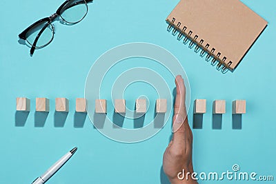 Hand of businessman stop dominoes continuous toppled Stock Photo