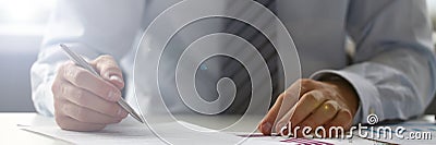 Hand of businessman in suit filling and signing with Stock Photo