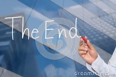 Hand of businessman write the text of The End. Stock Photo