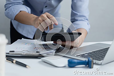 Hand businessperson doing financial and calculate on desk about cost at home office.Business investment Financing Accounting Stock Photo