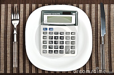 Hand calculator on food plate Stock Photo