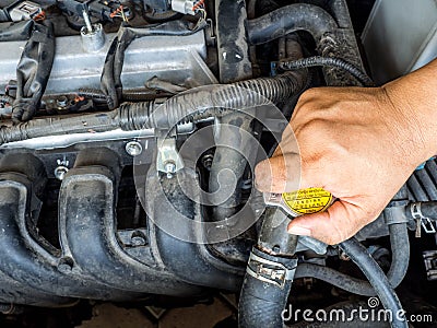 Hand of car mechanic working in auto repair service. He have fix old car engine streaked with dust and oil stains Stock Photo