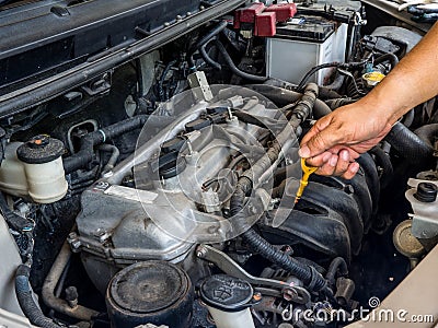 Hand of car mechanic working in auto repair service. He have fix old car engine streaked with dust and oil stains Stock Photo