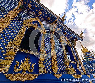 Hand-carved golden ornamentation of Blue Temple or Wat Rong Suea Ten at Chiang Rai Thailand Stock Photo