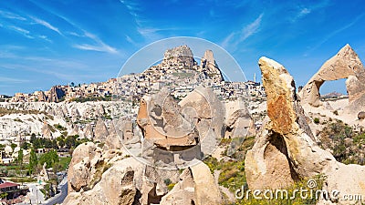 Hand carved rooms in limestone rocks and castle of Uchisar in Cappadocia, Turkey Stock Photo