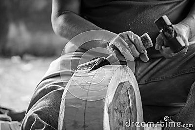 Hand of carver carving wood in blackand white color tone Stock Photo