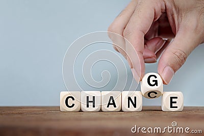 Hand Changing word from CHANGE to CHANGE On Wooden Cube Stock Photo