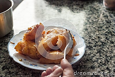 The hand of a chef serving cooked quince cuted in pieces. Stock Photo