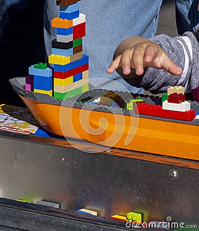 The hand of a child as he reaches for lego blocks Editorial Stock Photo